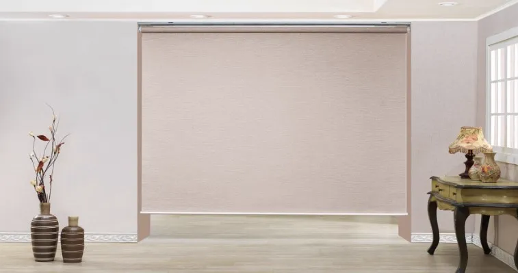 Linen roller shade lowered across a wide window